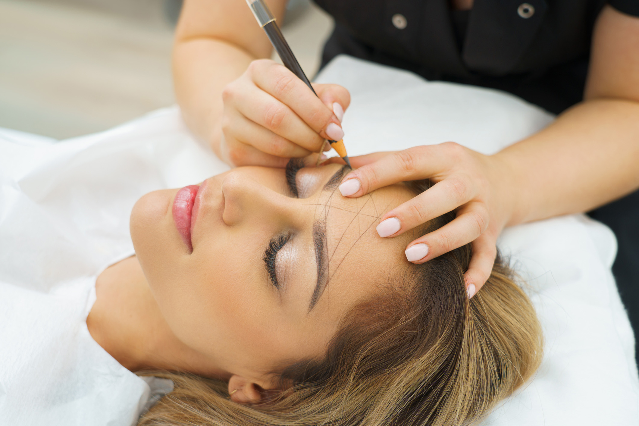 Woman receiving microblading permanent makeup services at Haven Permanent Cosmetics in Gig Harbor, Washington