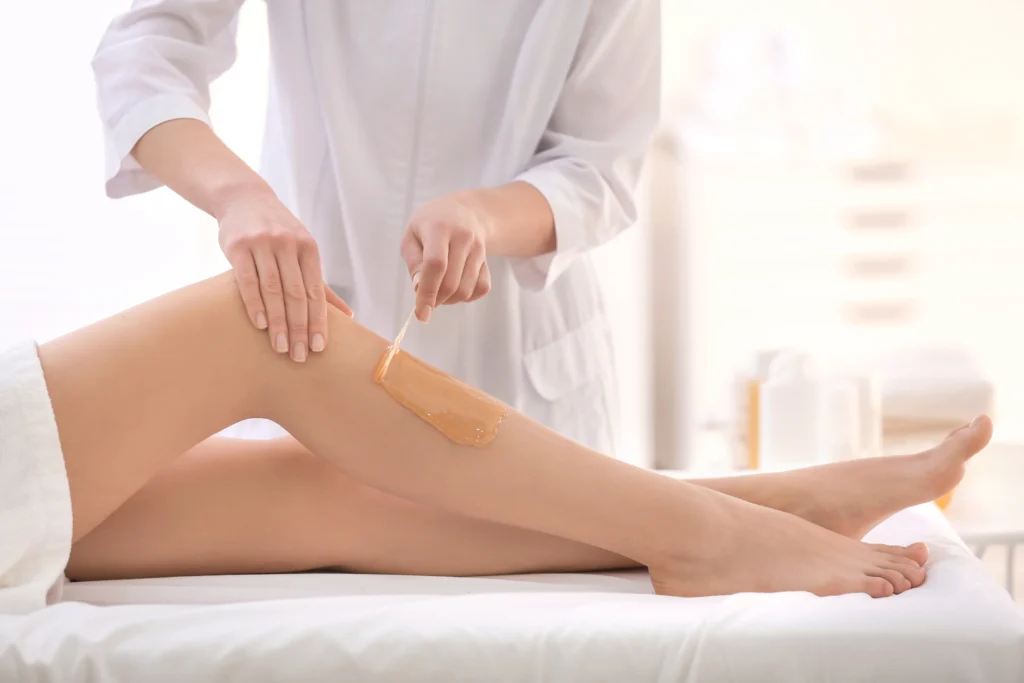 A Woman receiving waxing on her legs at Haven Permanent Cosmetics & Aesthetics in Gig Harbor, WA